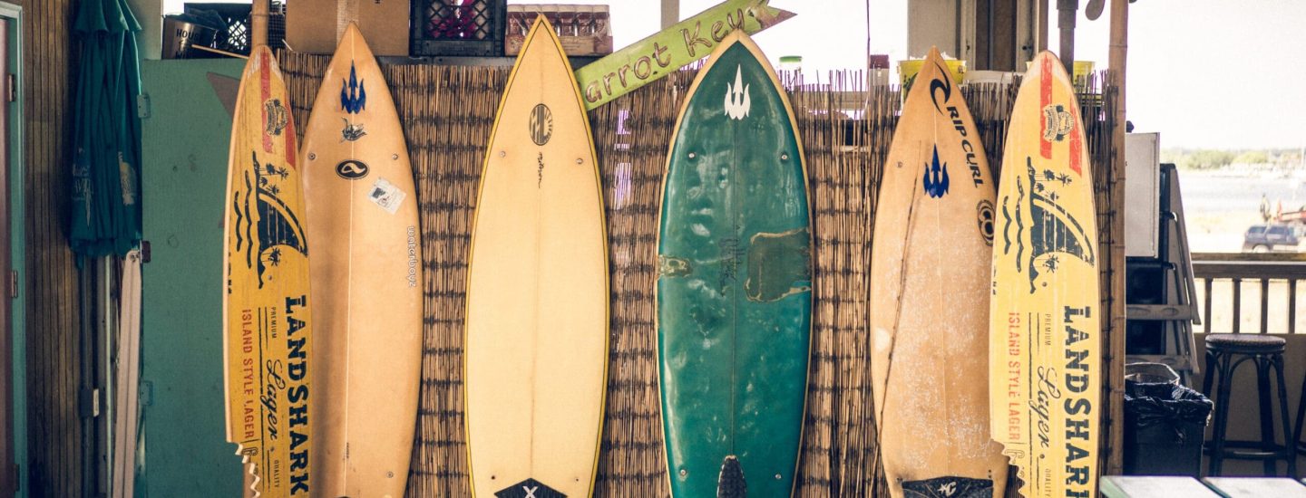 A picture showing surfboards leaning against a wall